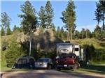 Tent and RV camping in a shaded site at Custer's Gulch RV Park & Campground - thumbnail