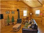 Cabin living room with wood stove at Custer's Gulch RV Park & Campground - thumbnail