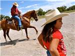 A girl in a cowboy hat standing in front of a horse at SKY UTE FAIRGROUNDS & RV PARK - thumbnail