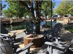 Lounge chairs around a fire pit at FORT AMARILLO RV RESORT - thumbnail