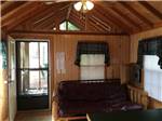 The living room area in a cabin rental at SCHROON RIVER CAMPGROUND & LODGING - thumbnail