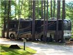 A motorhome parked in a gravel site at SCHROON RIVER CAMPGROUND & LODGING - thumbnail