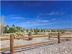View larger image of A wooden fence going thru the desert at DESERT VIEW RV RESORT image #6