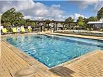 View larger image of Large swimming pool with lounge chairs at OAK FOREST RV RESORT image #10