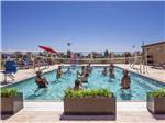 People playing volleyball in the swimming pool at SONORAN DESERT RV PARK - thumbnail