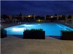 The swimming pool at night with the lights on at SONORAN DESERT RV PARK - thumbnail