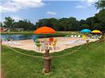 View larger image of Colorful chairs and umbrellas next to the lake at MILL CREEK RANCH RESORT image #5