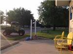 View larger image of A couple of yellow chairs in front of the office at KAMP KOMFORT RV PARK  CAMPGROUND image #7