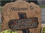 View larger image of The front entrance sign painted on a rock at KAMP KOMFORT RV PARK  CAMPGROUND image #10