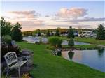 View larger image of RVs parked near pretty lake and green grass at TRAVERSE BAY RV RESORT image #1