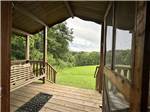 A view of grass and trees from a cabin - thumbnail