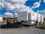 A fifth wheel trailer in a gravel RV site at ROSE VALLEY RV RANCH & CASITAS - thumbnail