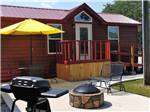 A cabin with fire pit and bbq pit at MUNCIE RV RESORT BY RJOURNEY - thumbnail