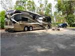 A motorhome in a gravel RV site at MIDWAY RV PARK - thumbnail