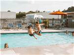 View larger image of A couple of boys jumping into the pool at LAKESIDE RV PARK image #1