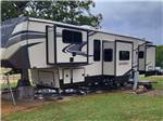 A fifth wheel trailer parked in a gravel site at CANTON I-20 RV PARK - thumbnail