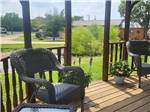 Wicker chairs and table on a deck at CANTON I-20 RV PARK - thumbnail