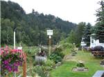 View larger image of Birdhouses and flowers at SANDY RIVERFRONT RV RESORT image #1