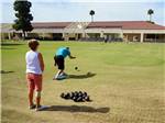 View larger image of Couple lawn bowling at PARADISE RV RESORT image #4