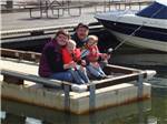 A family fishing off the dock at LOON LAKE LODGE & RV RESORT - thumbnail