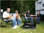 A group of people sitting around a fire ring at LOON LAKE LODGE & RV RESORT - thumbnail