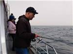 A man fishing off of a boat at BANDON BY THE SEA RV PARK - thumbnail