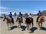 A group of people riding horses on the beach at BANDON BY THE SEA RV PARK - thumbnail