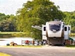 Parked RV near lake at Yogi Bear's Jellystone Park Clay's Resort - thumbnail