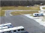 Motorhome and trailers parked in the storage area at JOLLY ACRES RV PARK & STORAGE - thumbnail