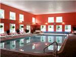 View larger image of Large indoor pool with lounge chairs at MEREDITH WOODS 4 SEASON CAMPING AREA image #12