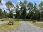 View larger image of A row of gravel RV sites at ADVENTURES EAST CAMPGROUND  COTTAGES image #10