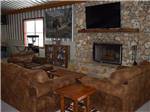 Couches around a fireplace at WILD FRONTIER RV RESORT - thumbnail