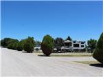 A row of gravel RV sites at ARBUCKLE RV RESORT - thumbnail