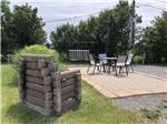 A fireplace and concrete patio in an RV site at CAMPING LA CLE DES CHAMPS RV RESORT - thumbnail