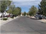View larger image of Paved road with gravel sites at IRON HORSE RV RESORT image #5