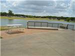 View larger image of Picnic table on the water at THE VINEYARDS CAMPGROUND  CABINS image #2