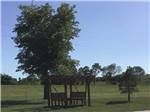 View larger image of Wooden benches with shade cover  at LAZY ACRES RV PARK image #6