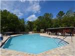 View larger image of Large swimming pool with lounge chairs at WILLISTON CROSSINGS RV RESORT image #1