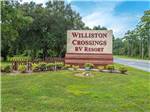Large entrance sign with fence at WILLISTON CROSSINGS RV RESORT - thumbnail