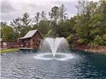 A fountain in the middle of the lake at WILLISTON CROSSINGS RV RESORT - thumbnail