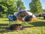 Tent next to fire pit at site North Port Huron Jellystone Park - thumbnail
