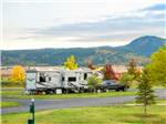 Fifth wheel trailer and black truck parked at site at ELKHORN RIDGE RV RESORT & CABINS - thumbnail