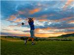 View larger image of Man golfing at sunset at ELKHORN RIDGE RV RESORT  CABINS image #4