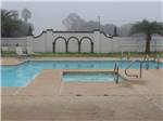 View larger image of The hot tub and swimming pool at LAZY PALMS RANCH RV PARK image #6