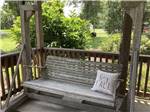 A swinging bench with a pillow at KOC KAMPGROUND - thumbnail