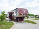 A fifth wheel trailer parked in a gravel site at HERITAGE ACRES RV PARK - thumbnail