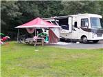 A covered picnic bench next to a motorhome at DAN RIVER CAMPGROUND - thumbnail