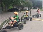 Kids driving pedal cars at WAUBEEKA FAMILY CAMPGROUND - thumbnail