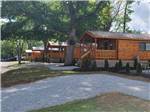A row of rustic rental cabins at WAUBEEKA FAMILY CAMPGROUND - thumbnail