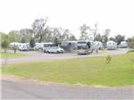 View larger image of RV campsite with motorhomes and trucks at IVYS COVE RV RETREAT image #4